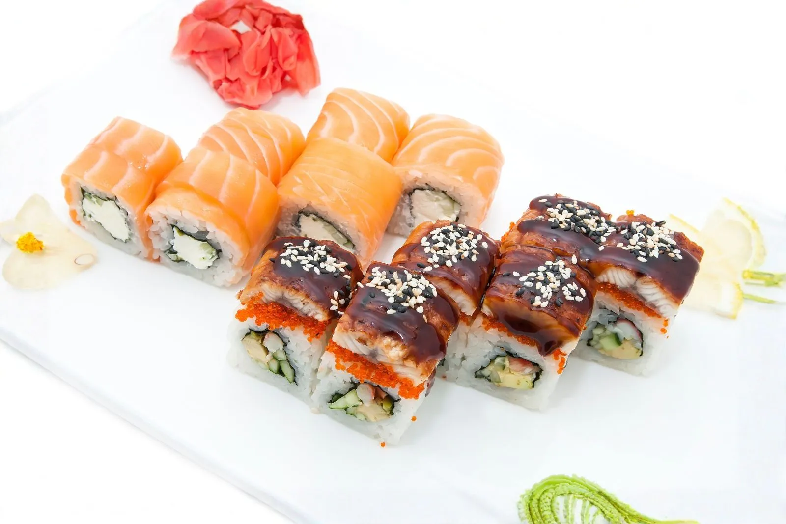 Platter of eel and salmon sushi rolls with garnishes