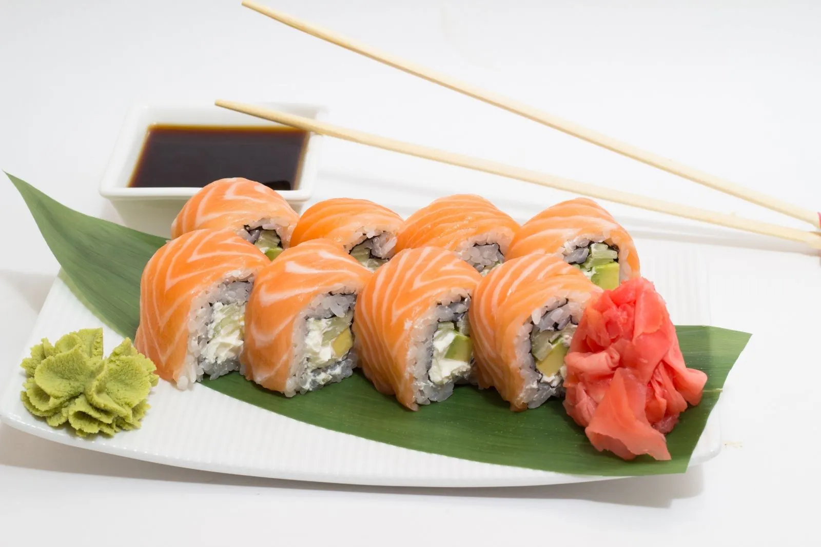 Salmon cream cheese maki sushi roll with wasabi and ginger